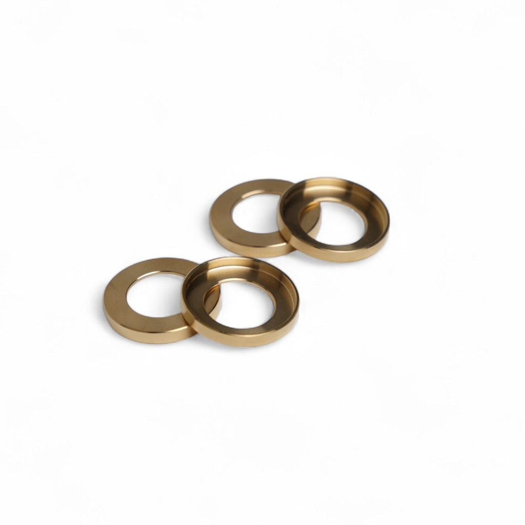 Three brass washers on a white background
