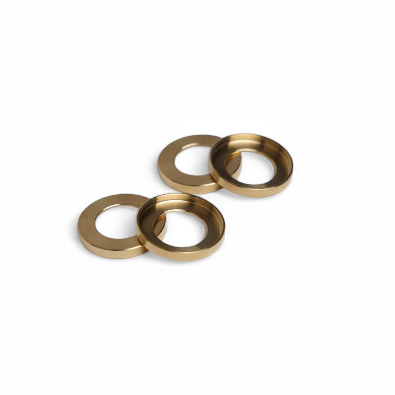 Three brass washers on a white background